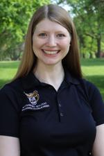 A professional headshot of Ruthie Paula in a black Oakland University shirt.